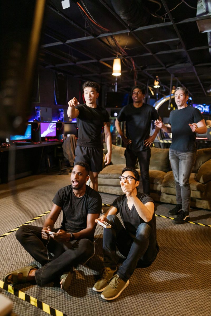 A diverse group of friends enjoying video gaming indoors, having fun and bonding.